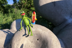 Kermit and Mr Hot Dog Lego Guy Climbing a Sculpture Along The Do